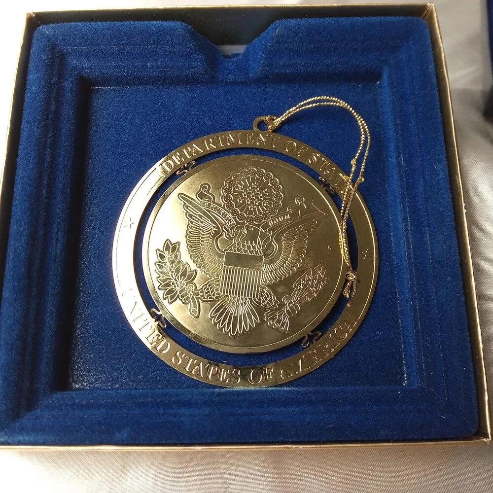 DEPARTMENT OF STATE GOLD TONE ORNAMENT IN BOX